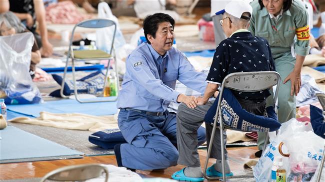 Japan PM visits flood disaster zone, promises help as new warnings issued